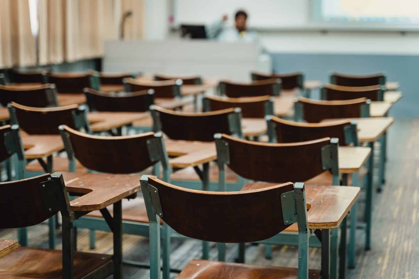 Empty classroom with rows of wooden chairs